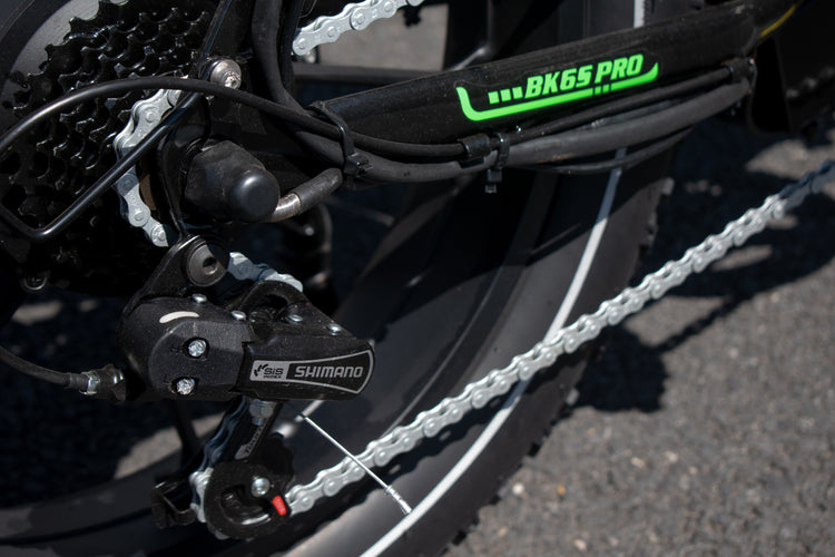 Close-up of a bicycle chain and gear system with 'BK6S PRO' and 'Shimano' branding.