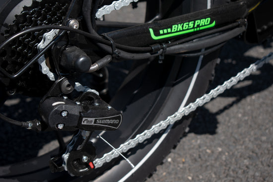 Close-up of a bicycle chain and gear system with 'BK6S PRO' and 'Shimano' branding.