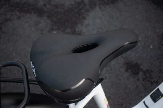 
Close-up of the electric bike saddle showing ergonomic design and shock-absorbing seat post